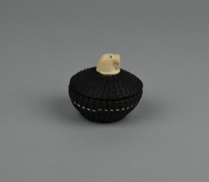 Image: Small  baleen basket with a single white band, walrus head finial 