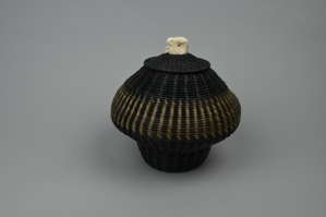 Image: large black and white baleen basket with eagle's head finial