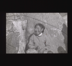 Image of Inuit woman sitting by tupik  [b&w]