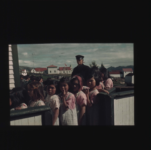 Image of Donald MacMillan and school girls by school fence