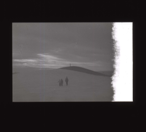 Image of Two crewmen and an Inuit walking in snow  [b&w]
