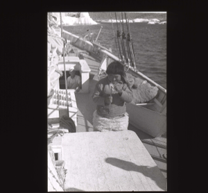 Image: Inuit man holding louse catcher, aboard  [b&w]
