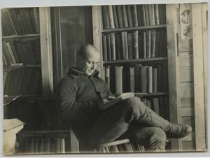 Image of Donald MacMillan reading in library of Borup Lodge