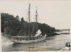 Image of The BOWDOIN steaming close to shore. Visitors aboard