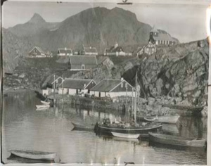 Image of West Greenland village. Boats moored in small harbor