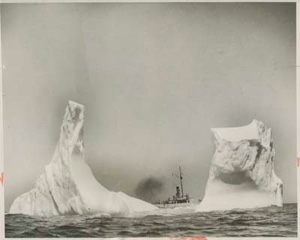 Image: Coast Guard cutter seen between two sections of an iceberg