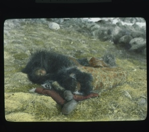 Image: Two Inuit women asleep in sleeping bags on the ground
