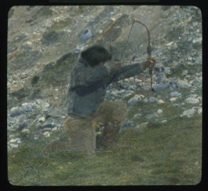 Image of Inuit on one knee, ready to shoot with bow and arrow