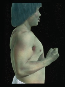 Image: Portrait: Inuit man standing in profile. Naked to waist.
