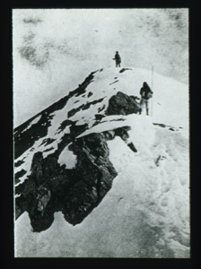 Image: Two men climbing snowy peak