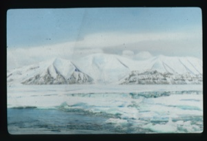 Image of Snow covered hills with some striation showing. Ice in foreground