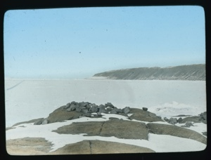 Image: Ice sheet on sea. Rocks in foreground