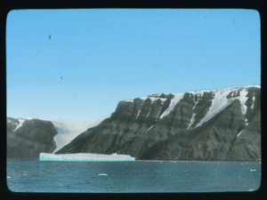Image of Large ice floe by coastal hills