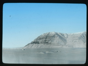 Image of Looking across ice to striated hills with snow                                 
