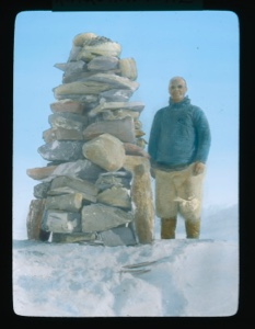 Image: Elmer Ekblaw standing by tall rock cairn