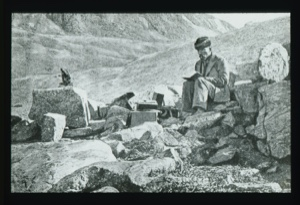 Image of Drawing: Explorer in western dress suit sitting on rocks and reading...