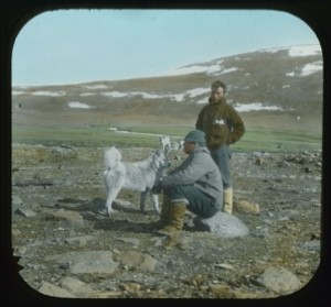 Image: Lange Koch (standing) and Elmer Ekblaw (sitting on rock)  with dog 