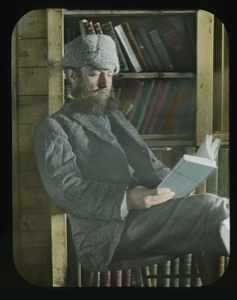 Image: Maurice Tanquary seated in library, reading