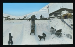 Image: Men pulling sledge, loaded with supplies, up to Borup Lodge....