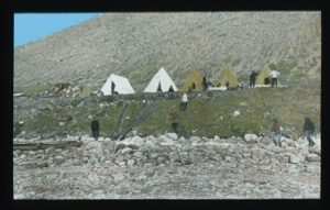 Image of Tents near Borup Lodge. Eight men at various tasks....