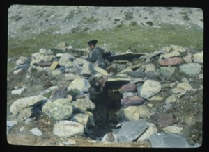 Image of Woman working on stone igloo