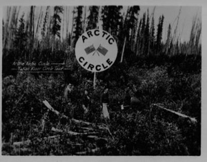 Image: People at the Arctic Circle sign on the Yukon River Circle Tour