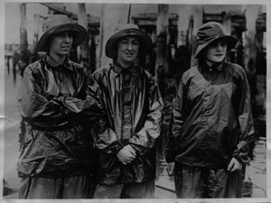 Image of Three women crew mnembers on the SACHEM. Mrs. Rowe Metcalf, Marion Smith. Miss Maude Fisher, in rain gear