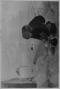 Image of Man dipping water into a teakettle. Soviet polar Expedition ...