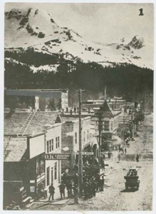 Image: A main street, snow-covered mountains beyond