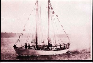 Image: The BOWDOIN. Two people wave from the bow 