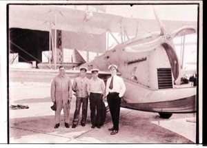Image of Four men standing near plane