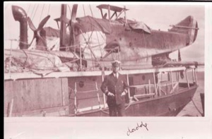 Image of Man standing by S.S. PEARY. Planes aboard, "daddy" written on border