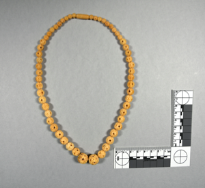 Image: ivory bead necklace of carved and graduated beads and ivory clasp