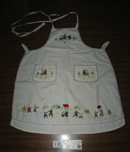 Image: Embroidered apron with Inuit figures and schoolhouse