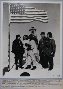 Image of photograph of Adm. Byrd with 4 men and American flag flying (copy photo), Little America