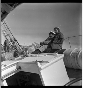 Image of "Shipwreck photo" - MacMillan and Miriam sit on tilted deck near hatch
