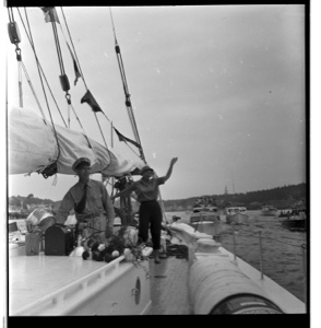 Image of ? on deck, Miriam standing at wheel - waving