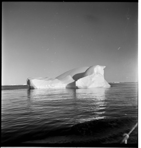 Image of Wave-washed iceberg with reflection