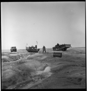 Image: Three vehicles, men and a barrel on Greenland ice cap