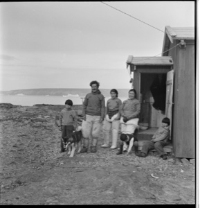 Image of Eskimo [Inuit] family by its [their] home