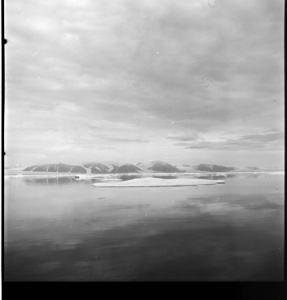 Image of Ellesmere Island in distance, ice pan, clouds