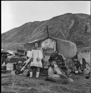 Image of Inuit woman outside her Pond Inlet home