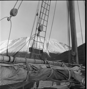 Image: Looking over spar and rigging to snowy mountain