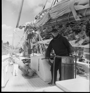 Image of MacMillan stands at wheel going through Bras d'Or canal