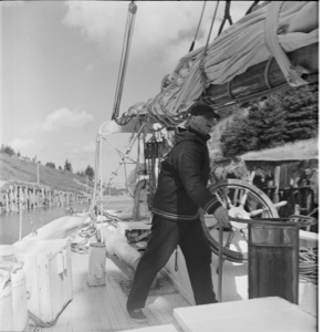 Image of MacMillan stands at wheel going through Bras d'Or canal