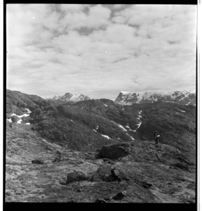 Image: Rutherford Platt standing on rocky landscape, heavy clouds above