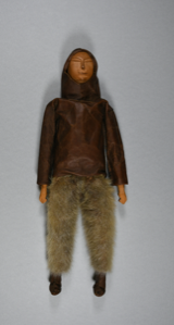 Image of Doll with sealskin anorak, boots, and trousers, beaded decoration on back of hood