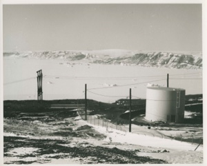 Image of Area around large storage tanks; low mountains beyond