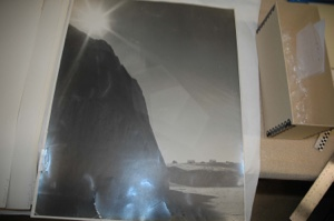 Image of Winter sun seen over snow mound. Antenna and ? beyond