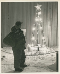 Image of Man looking at outdoor Christmas "tree" lights, Thule AFB